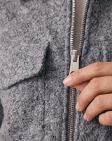 Zoe Coat in gray — macro detail of the bouclé texture, zip and pocket flap
